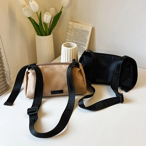 Minimalist cylindrical crossbody bags in beige and black with Forever Young straps