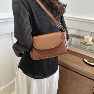 Brown vintage shoulder bag with minimalist rectangular silhouette and adjustable strap