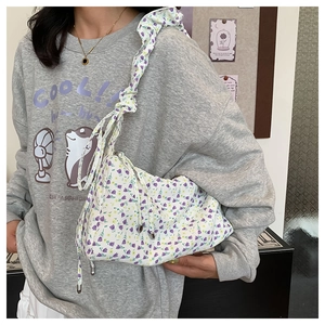 Detail of floral tote bag showing ruched shoulder strap and delicate flower pattern