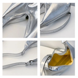 Detail view of silver pleated tote bag with yellow lining and adjustable metal buckle