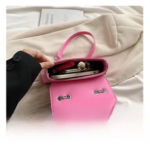 Interior view showing capacity for smartphone and cosmetics in a bright pink crossbody bag