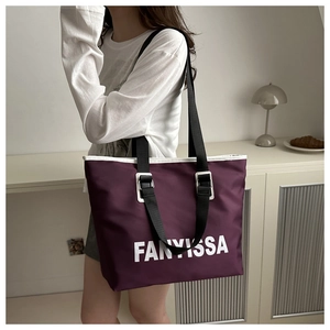 Detail of purple waterproof nylon tote bag with FANVISSA text and black shoulder strap