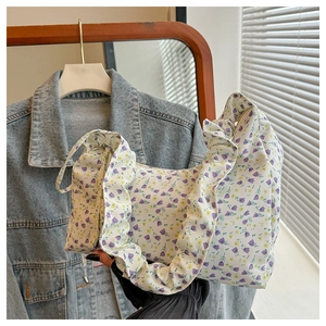 Detail of floral ruffle shoulder bag with purple tulips and yellow flower patterns