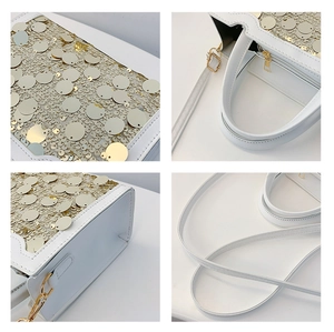 Vista macro della borsa bianca con paillettes dorate e dettaglio della cerniera metallica