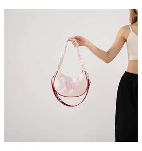 Détail du sac demi-lune blanc avec broderie papillon et bandoulière à lettres LOVE