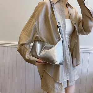 Chic silver crescent hobo bag with metallic pleated texture for shoulder wear