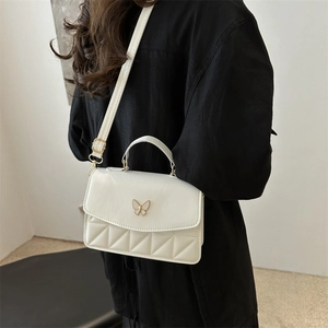 Elegant white PU leather crossbody bag with butterfly clasp and quilted diamond pattern