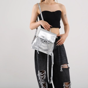 Sleek metallic silver PU leather backpack with flap closure and adjustable straps