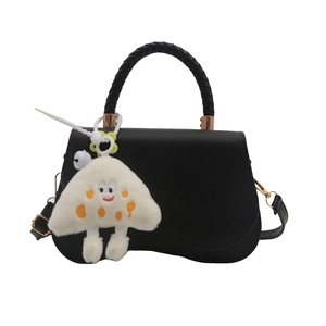 Chic black saddle crossbody bag with woven handle and plush mushroom charm