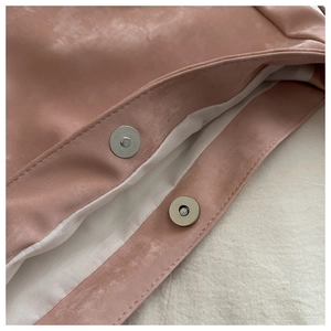 Detailed close-up of pink faux suede tote bag featuring silver magnetic snap closure