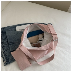 Pink suede hobo bag interior capacity showing laptop, umbrella and makeup palette