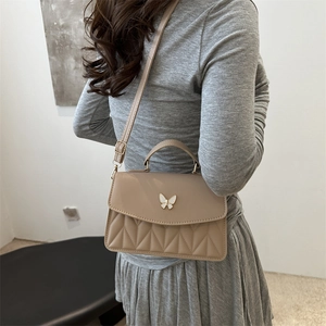 Chic beige crossbody bag with butterfly clasp and quilted pattern for women