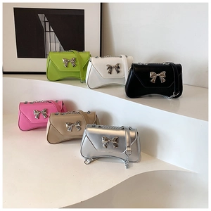 Detailed row of mini flap bags with metal bows and chain straps in multiple vibrant colors