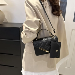 Two-piece black quilted leather shoulder bag set with small pouch and metal bar detail
