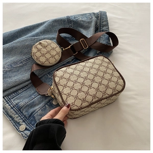 Detail view of retro plaid crossbody bag with matching round coin purse on denim background