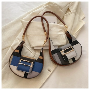 Detail of two vintage-style color-block half-moon underarm bags with gold buckles