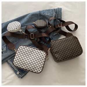 Close-up of vintage check pattern crossbody bags with matching round coin purse charms