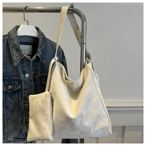 White faux leather tote bag set including a large hobo bag and a matching small zipper pouch