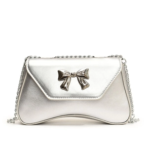 Silver metallic chain bag with mirror finish and bow detail in a modern curved design