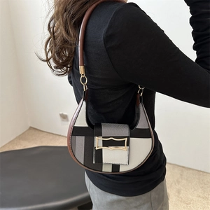 Hobo shoulder bag featuring black and white geometric pattern with brown strap