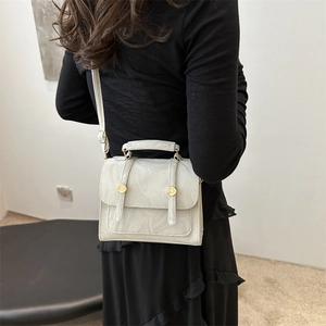 Chic beige marble pattern PU leather crossbody bag shown on a model for size and style