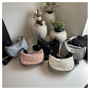 Detailed close-up of nylon quilted hobo bags in assorted colors with wide straps