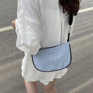 Large light blue nylon crescent crossbody bag with sporty black wide strap for women