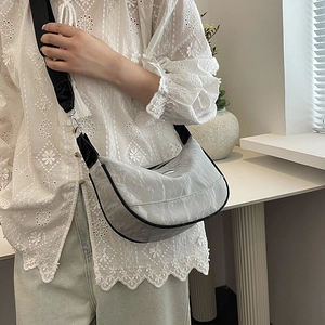 2024 stylish grey crescent bag with wide sport strap shown on model in casual setting