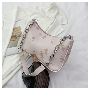 Detail of pink floral baguette bag with silver chain strap and plum blossom print