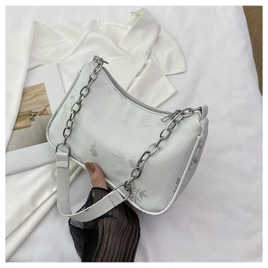 Top view of butterfly print shoulder bag with silver chain strap on white fabric