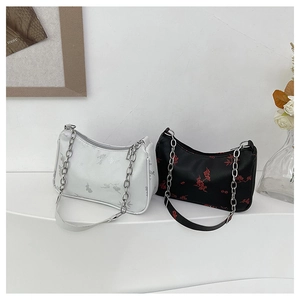 Detail of white and black butterfly print baguette bags with chain and leather straps