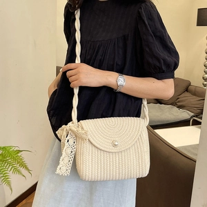 Beige straw woven crossbody bag with pearl buckle and lace bow for summer beach style