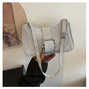 Detail of grey shoulder bag featuring textured marble pattern and silver square buckle