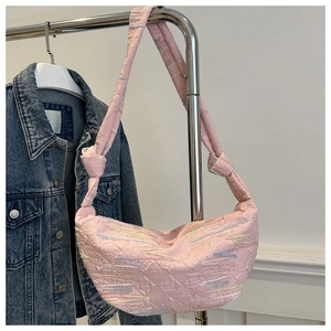 Detail of pink half-moon shoulder bag with colorful wave embroidery and textured fabric