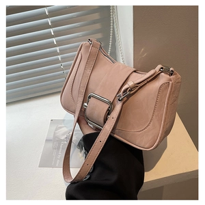 Detail of mauve PU leather shoulder bag with silver buckle and natural creased texture