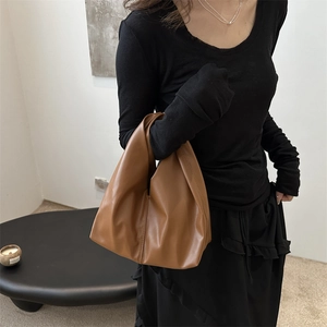 Minimalist brown hobo tote bag in soft leather styled with casual black outfit