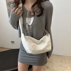 White crescent dumpling bag with colorful wave embroidery and wide shoulder strap