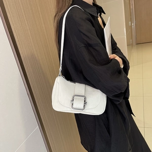 Minimalist white leather underarm bag with large silver rectangular buckle on a model