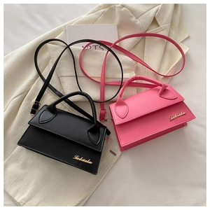 Chic black and pink crossbody bags with gold logo on white fabric surface