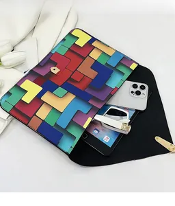 Detail view of large envelope clutch bag showing spacious interior for phone and sunglasses