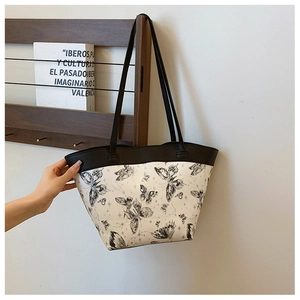 Detail of artistic butterfly and constellation print on a white large tote bag