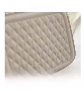 Close-up of white quilted faux leather texture with elegant diamond stitch pattern