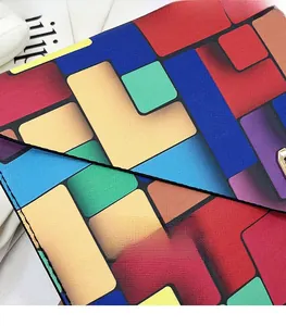 Detailed close-up of precise stitching on a colorful geometric leather envelope clutch bag