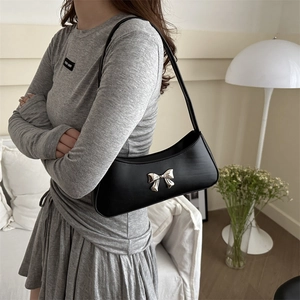 Chic black shoulder bag with silver bow accent and minimalist retro synthetic leather design