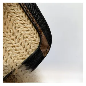 Macro detail of the woven straw texture and high-quality edge stitching on a tote bag
