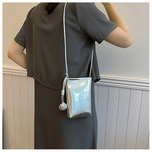Detail view of the silver metallic mini crossbody phone bag with reflective mirror finish