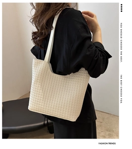 Close-up of the elegant white woven texture on a minimalist large capacity tote bag