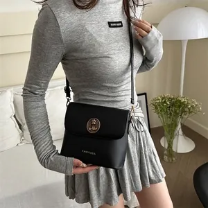 Classic black flap crossbody bag featuring a golden bear clasp and slim shoulder strap