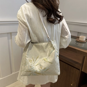 Elegant off-white satin shoulder bag with gold bamboo and bird embroidery in oriental style