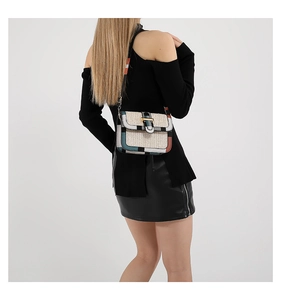 Detail of woven crossbody bag showing mixed color textures and jacquard shoulder strap